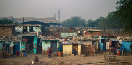 India, Delhi - Dec 28, 2015: Global TV concept. In this indian shack barely fit bed. But telly is definitelyのeditorial素材