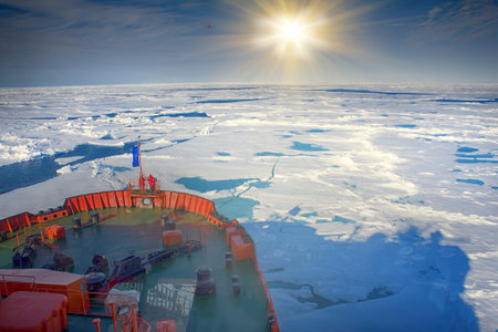 North pole - 2 July 2016: icebreaker makes its way to North pole through pack ice. On bow of ship tourists, ice box with openningsのeditorial素材