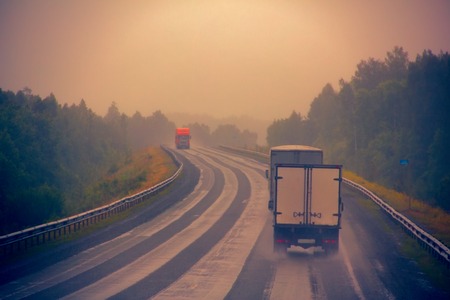 Russia, Novosibirsk - July 27, 2016: lorry on highway-delivery of goods in bad weather threat....