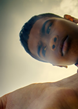 India, pondicherry - February 15, 2016: Portrait (head) of Indian young men (Hindu, Indo-Aryan group) that demonstrates open hand. Art photography, unusual perspectiveのeditorial素材