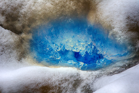 Unity of opposites. Combination of dirty and crystal clear blue iceの写真素材