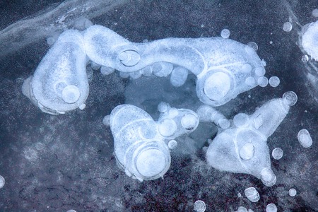 background ice beautiful after a heavy frost. frozen in ice cavity with oxygenの写真素材