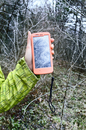 smartphone tracking travel on trails. orientation on forest thicket by gps Navigator