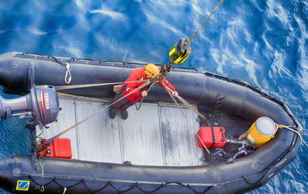 North pole - 2 July 2016: Arctic ocean, Franz-Josef Land. Tourist boats coming on Board of icebreaker. In background glacier in fogのeditorial素材