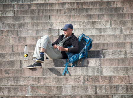 Helsinki , Finland - August 22, 2017: Cathedral Of St. Nicholas, tourists rest on steps of monumental building attractionsのeditorial素材