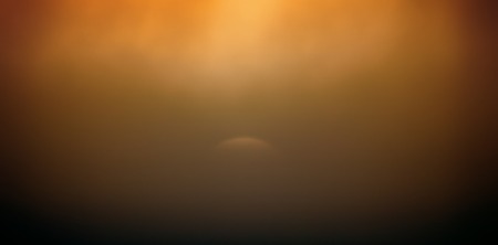 The setting sun in the misty haze. Yellow summer sunset promises Sunny weather the next dayの写真素材