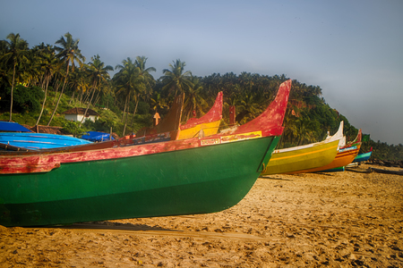 Painted and carving boats of Indian fishermen on beaches of Kerala. Love attitude to work and life (Indian civilization)の写真素材