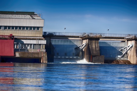 Hydroelectric power on river. Power site (target) is partly open and water gushingの写真素材