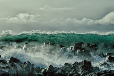 turbulent waves of Pacific ocean and rugged beauty of basalt rocks
