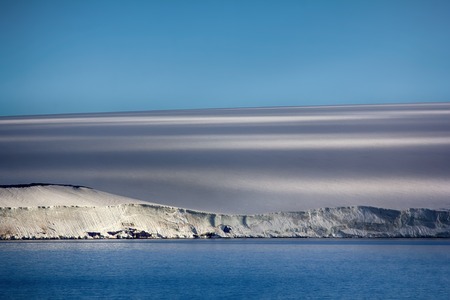 Islands along British channel. Glaciers, icefall, outlet glacier, snowfields and rock outcrops. Glacial shield of George Land and Hayes Island. Above line of cliffs is the ice dome. Franz Joseph Landの写真素材