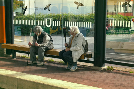 rasstat, Germany - September 13, 2017: Maintaining health for elderly. Heel-and-toe walk. Women with ski poles stop. On glasses stop caused silhouettes of birds of prey to broken birds and peopleのeditorial素材