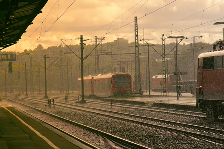 Modern high speed train. traffic of passenger trains in Europe outside metropolis. heavy rain while...