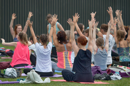 Saint Petersburg, Russia - July 30, 2017: yoga festival on lawn in Park in center of metropolis. Summer holiday of sport and healthのeditorial素材