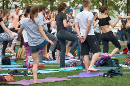 Saint Petersburg, Russia - July 30, 2017: yoga festival on lawn in Park in center of metropolis. Summer holiday of sport and healthのeditorial素材