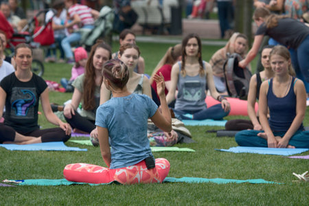 Saint Petersburg, Russia - July 30, 2017: yoga festival on lawn in Park in center of metropolis. Summer holiday of sport and healthのeditorial素材