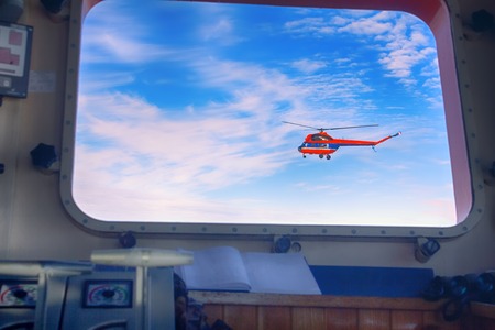 Helicopter ice reconnaissance in window of atomic icebreaker, right on course. Ship wiringの写真素材