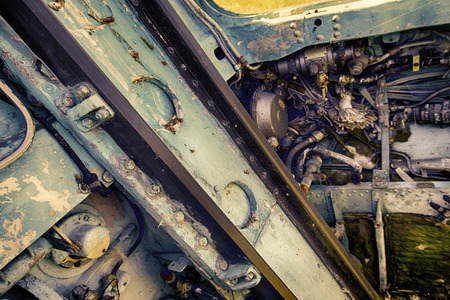 Control units made of aluminum alloy in cockpit of crashed military aircraft. pipes, wiring, pumps,...