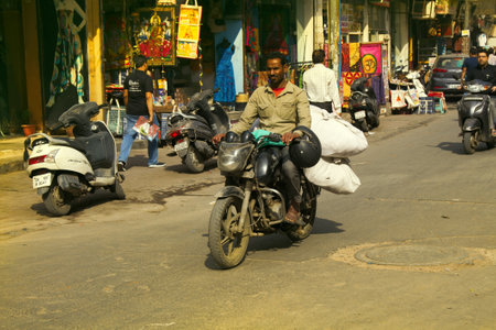 India, new Delhi - March 1, 2018: the buyer from the market. biker with big bags is on the market streetのeditorial素材