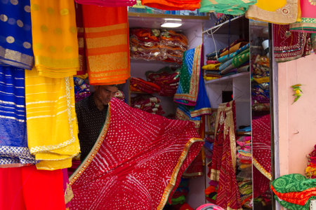 India, Pushkar-March 3, 2018: main charm of the Bazaar. shop beautiful world famous Oriental fabrics and outfits.のeditorial素材