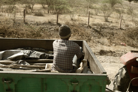 India, Jaisalmer - March 5, 2018: ryot sits in the tractor trailer. Daily life in Indian cities and villages, street photo sketchesのeditorial素材