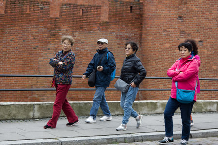 Warsaw, Poland - September 28, 2017: Daily life of the European city (city's day-to-day activities, daily routine). A group of tourists from Asiaのeditorial素材