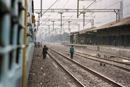 India, Pune - April 6, 2018: usual situation for Indian railway stations. people are not safe walking on the railroad tracksのeditorial素材