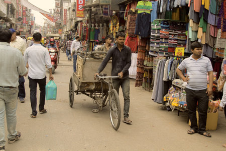 India, new Delhi - March 1, 2018: bike cargo rickshaw driver go in the middle of the market streetのeditorial素材