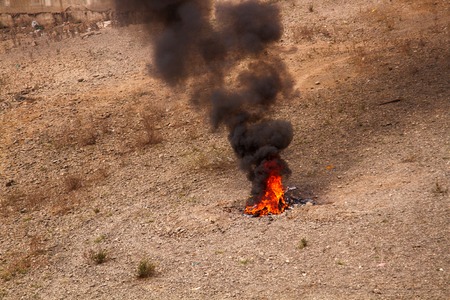 incineration of toxic waste in fire, acrid and black smokeの写真素材