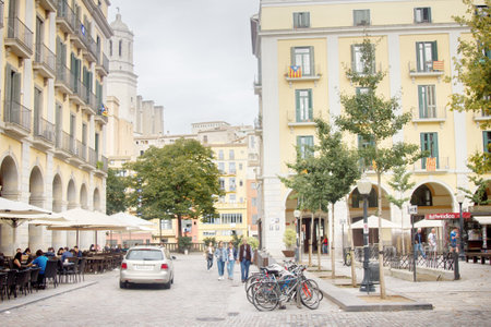 Spain, Girona - October 1, 2017: The old square with its pavement street cafesのeditorial素材