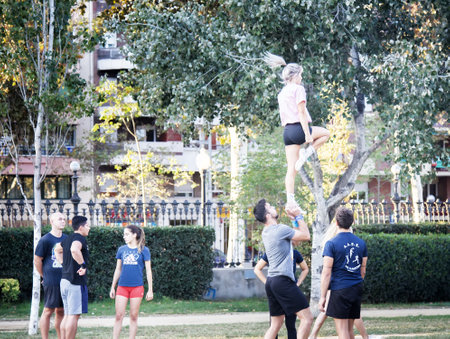 Spain, Barcelona - October 7, 2017: Acrobalance is combination of two athletic art forms, among youth fans in parkのeditorial素材