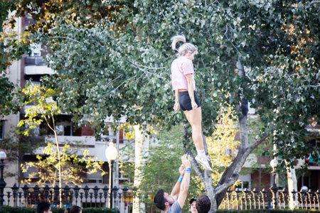 Spain, Barcelona - October 7, 2017: Acrobalance is combination of two athletic art forms, among youth fans in parkのeditorial素材