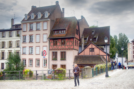 Strasbourg, France - September 19, 2017: embankment, bridge, medieval houses with Mock Tudor elementsのeditorial素材