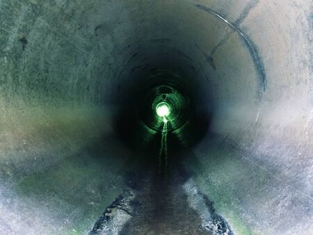 Drainage pipe under the highway (culvert). Filming inside the pipe.