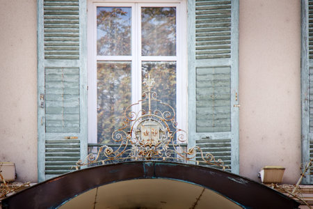 Limoges, France - September 28, 2017: front entrance, window, and wrought-iron knight coat of arms with sword and liliesのeditorial素材