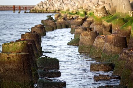 The seawall around the sea port facilities is made of concrete tetrapods (traveling-wave protection), rubble-mound breakwaterの写真素材