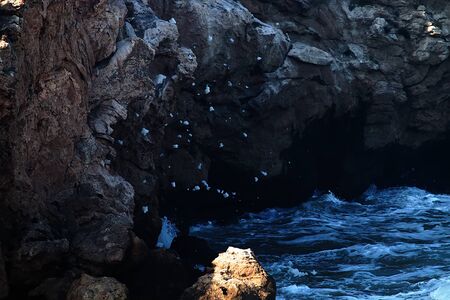 Limestone outlier goes into the sea in form of a stone Cape. Coastal erosion of softer rocksの写真素材