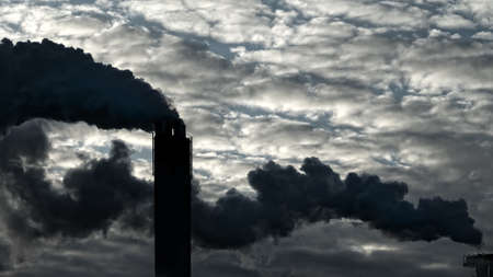 Thick clouds of dirty smoke from plant pollute atmosphere. Problems of planet pollution and global warmingの写真素材