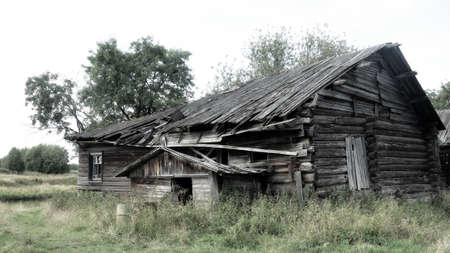 Old wooden house in Arkhangelsk region, a Residential village home in a forest village, Abandoned people and boarded up house. Russiaの写真素材