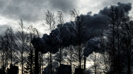 Thick clouds of dirty smoke from plant pollute atmosphere. Problems of planet pollution and global warmingの写真素材