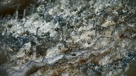 Water backgrounds with foam spray fast flow. The water in mad flows with droplets and whirlpools of waterfalls.の写真素材