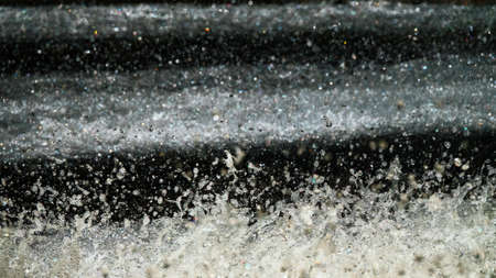 Water backgrounds with foam spray fast flow. The water in mad flows with droplets and whirlpools of waterfalls.の写真素材