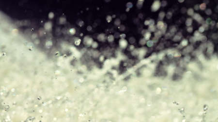 Water backgrounds with foam spray fast flow. The water in mad flows with droplets and whirlpools of...