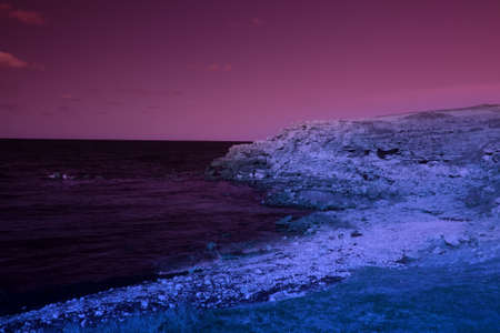 Mystical seaside with rocks. The magic and beauty of the sea. Surrealistic art infrared photo