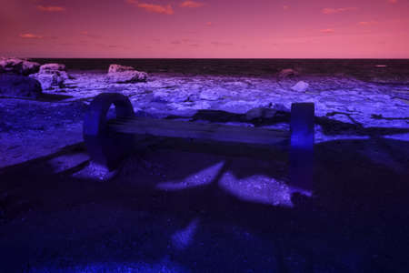 Bench for watching the sea. The magic and beauty of the sea. Surrealistic art infrared photo