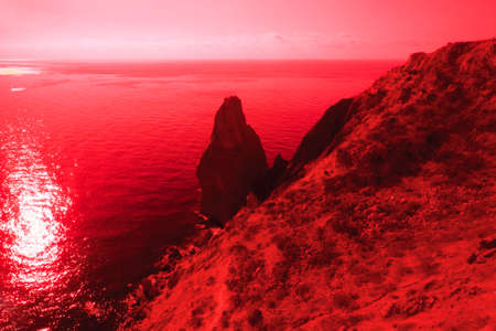 Damn finger, finger-stone coastal vertical rock. Fantasy in red tones . Thermal Impressionismの写真素材