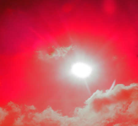 Red disturbing clouds and bloody sun. The Day of the Last Judgment fantasy. Surrealistic art infrared photoの写真素材