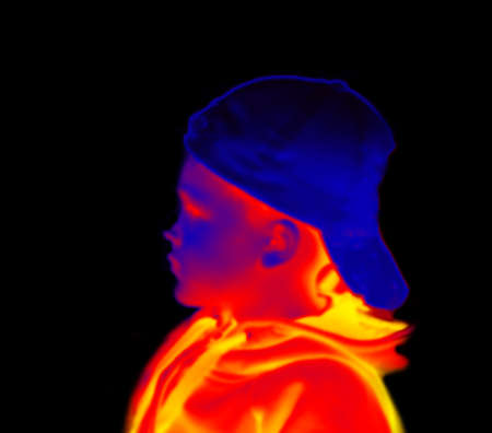 Teen in a cap with a visor back. illustration of thermal image. Blurred unrecognizable peopleの写真素材