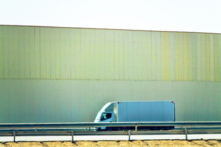 Protective wall on the highway protects from dust and noise (noise screen, sound-proof wall), high noise level. Different types of light and heavy transport on the background of the wallの写真素材