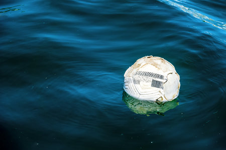 A soccer leather ball floats on the sea. A soccer ball floats on the sea. Football without borders,...