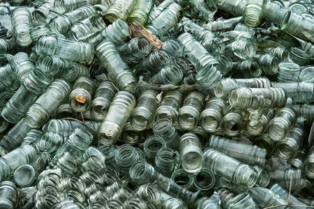 Empty glass sauce jars (industrial glass container) piled high, production has stopped, production...
